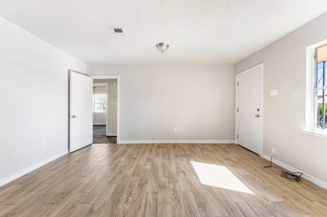 4637 Carmen St, Houston, TX 77051 - empty room featuring healthy amount of natural light, light wood-style floors, and baseboards