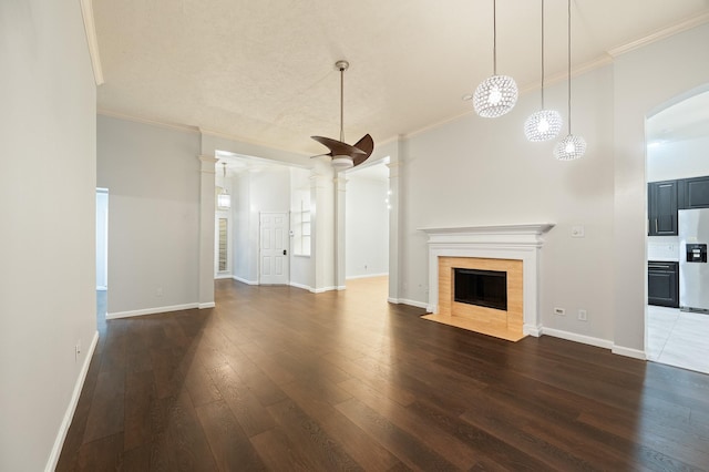 7624 Lone Meadow Ct, Houston, TX 77095 - unfurnished living room with a tiled fireplace, dark wood-style floors, crown molding, baseboards, and decorative columns