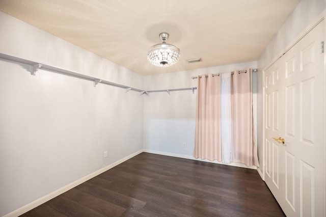 7624 Lone Meadow Ct, Houston, TX 77095 - spacious closet featuring dark wood finished floors and a chandelier