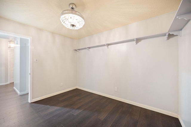 7624 Lone Meadow Ct, Houston, TX 77095 - empty room with dark wood-style floors, baseboards, and a chandelier
