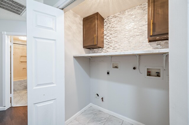 7624 Lone Meadow Ct, Houston, TX 77095 - laundry room with gas dryer hookup, washer hookup, electric dryer hookup, light marble finish floors, and baseboards