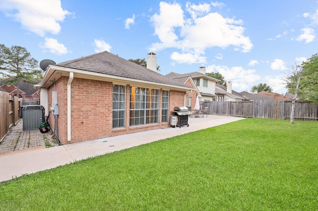 7624 Lone Meadow Ct, Houston, TX 77095 - rear view of house with brick siding, a patio area, a chimney, and a shingled roof