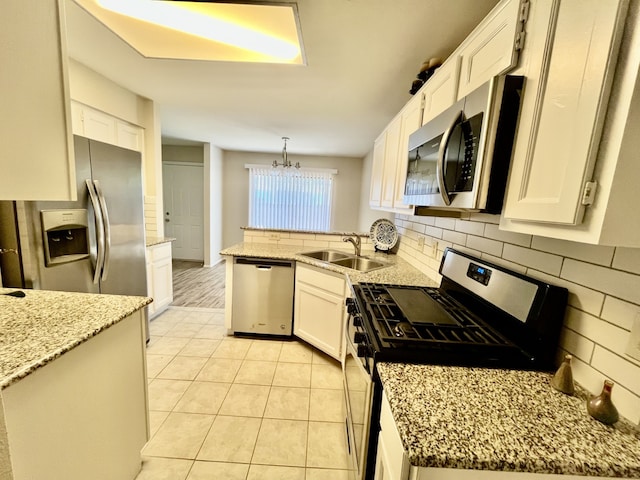 2711 Grants Lake Blvd Unit 203, Sugar Land, TX 77479 - kitchen with stainless steel appliances, a sink, a peninsula, and decorative backsplash