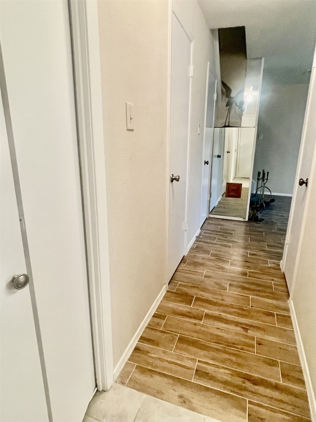 2711 Grants Lake Blvd Unit 203, Sugar Land, TX 77479 - corridor with wood finish floors and baseboards