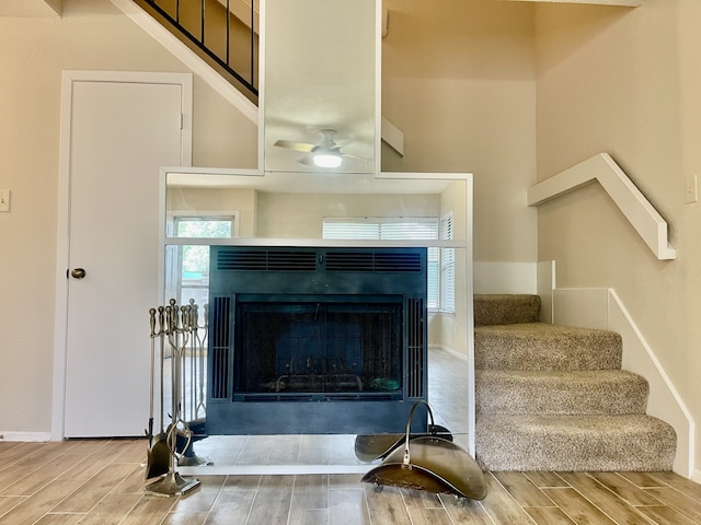 2711 Grants Lake Blvd Unit 203, Sugar Land, TX 77479 - detailed view of wood tiled floors, a fireplace, a ceiling fan, and baseboards