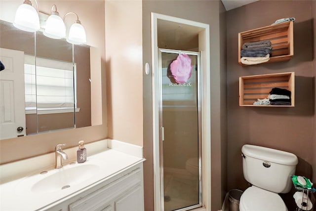 full bathroom with toilet, a shower stall, and vanity