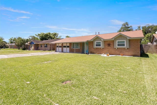 single story home with driveway, a garage, and brick siding