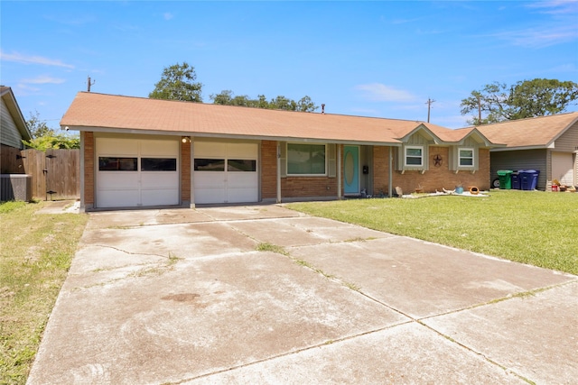 view of front of property with concrete driveway, an attached garage, a front lawn, and brick siding