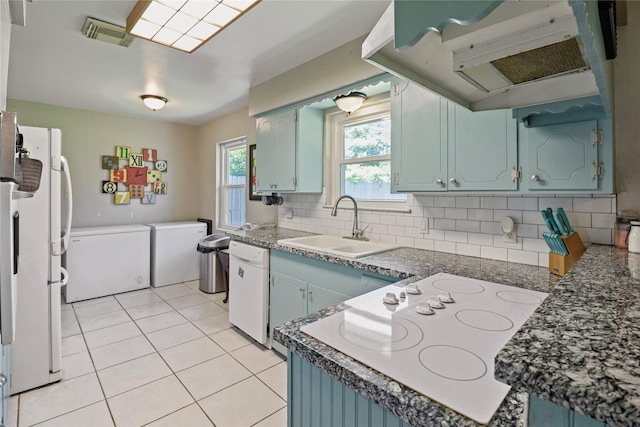 kitchen featuring ventilation hood, white appliances, tasteful backsplash, a sink, and light tile patterned floors