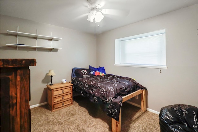 bedroom featuring light colored carpet, baseboards, and ceiling fan