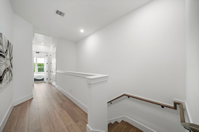 7117 Goforth St, Houston, TX 77021 - corridor featuring an upstairs landing, attic access, wood-type flooring, baseboards, and recessed lighting