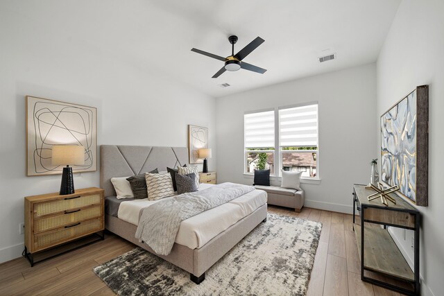 7117 Goforth St, Houston, TX 77021 - bedroom with hardwood / wood-style flooring, baseboards, and a ceiling fan