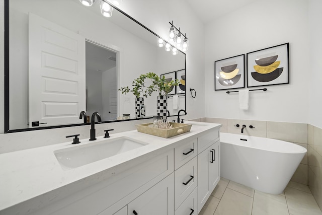 7117 Goforth St, Houston, TX 77021 - full bath with tile patterned floors, a soaking tub, and double vanity