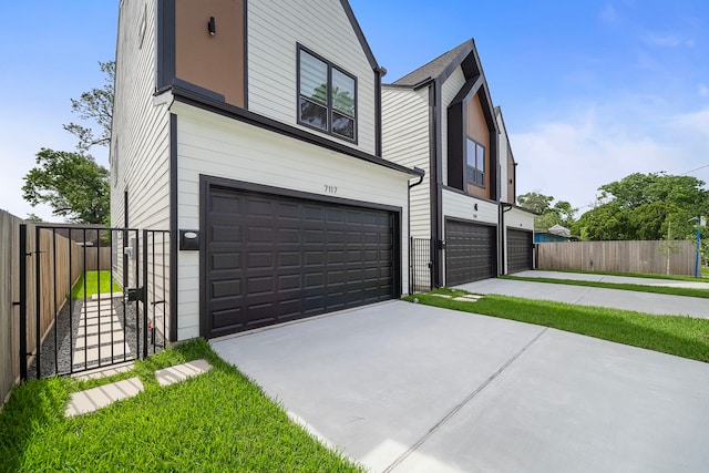 7117 Goforth St, Houston, TX 77021 - contemporary house with a garage, concrete driveway, and fence