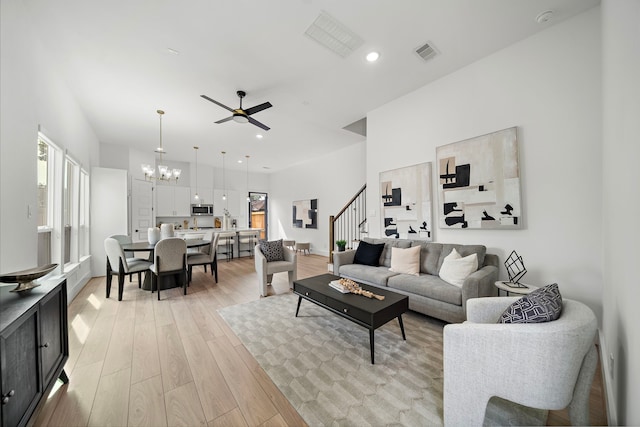 7117 Goforth St, Houston, TX 77021 - living area featuring stairs, a chandelier, light wood-style flooring, a ceiling fan, and recessed lighting