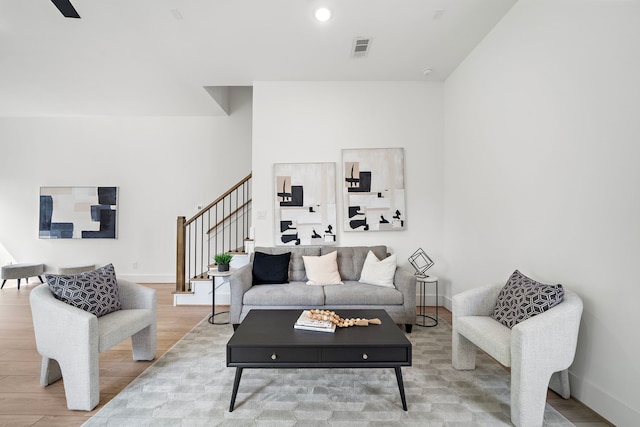 7117 Goforth St, Houston, TX 77021 - living area featuring stairs, wood finished floors, and baseboards