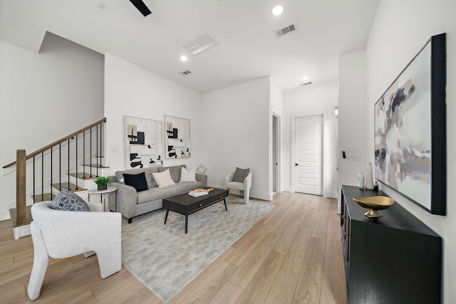 7117 Goforth St, Houston, TX 77021 - living area featuring stairs, light wood finished floors, recessed lighting, and baseboards