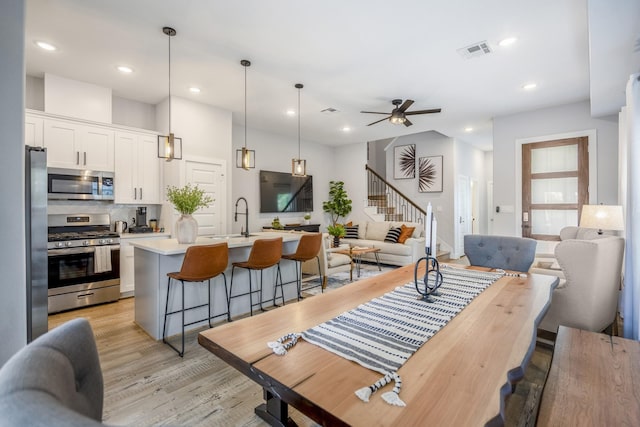 3710 Noah St, Houston, TX 77021 - kitchen featuring appliances with stainless steel finishes, open floor plan, a kitchen bar, light countertops, and recessed lighting