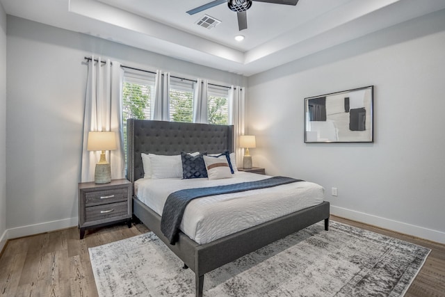 3710 Noah St, Houston, TX 77021 - bedroom featuring a tray ceiling, baseboards, wood finished floors, ceiling fan, and recessed lighting
