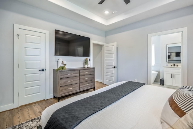 3710 Noah St, Houston, TX 77021 - bedroom with wood finished floors, ensuite bath, baseboards, a tray ceiling, and recessed lighting