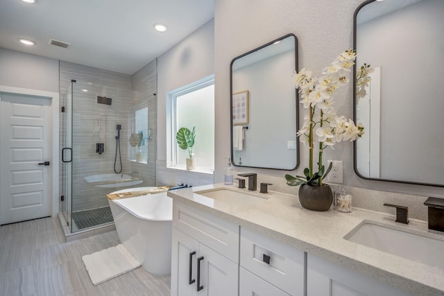 3710 Noah St, Houston, TX 77021 - full bath with a shower stall, a freestanding bath, double vanity, recessed lighting, and tile patterned flooring