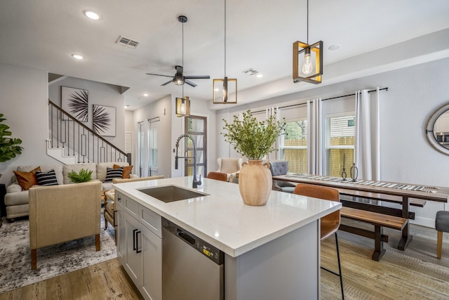 3710 Noah St, Houston, TX 77021 - kitchen with a sink, dishwasher, open floor plan, light wood-style flooring, and an island with sink