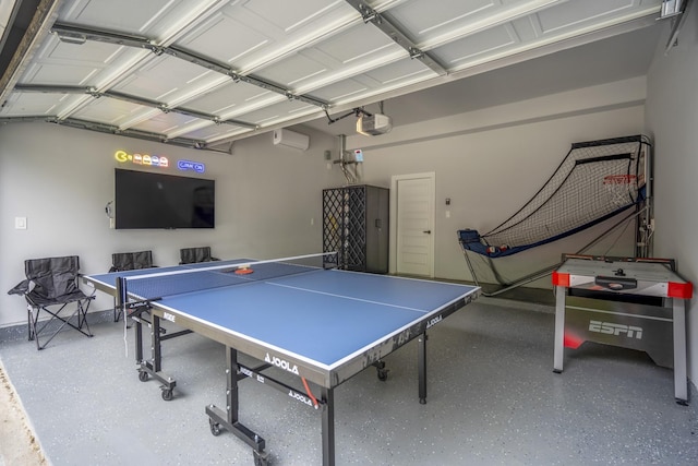 3710 Noah St, Houston, TX 77021 - recreation room with a garage, speckle patterned floor, and a wall unit AC