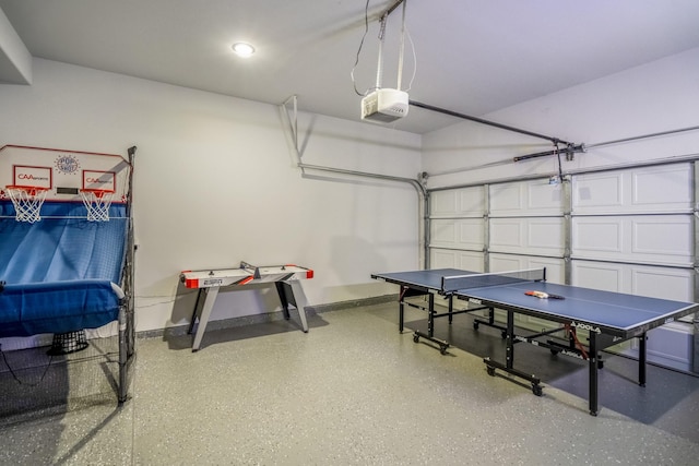 3710 Noah St, Houston, TX 77021 - recreation room featuring a garage, speckled floor, and baseboards