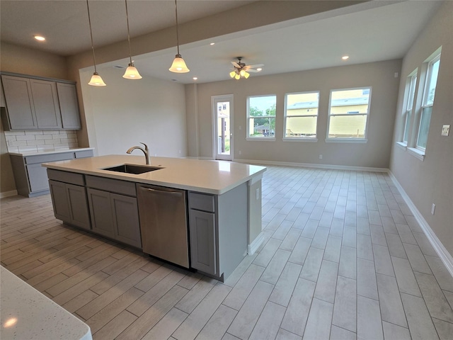 4029 Boardwalk Blvd, Seabrook, TX 77586 - kitchen featuring stainless steel dishwasher, a sink, gray cabinets, light wood finished floors, and recessed lighting