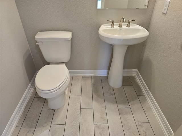 4029 Boardwalk Blvd, Seabrook, TX 77586 - bathroom with wood tiled floors, toilet, and a sink