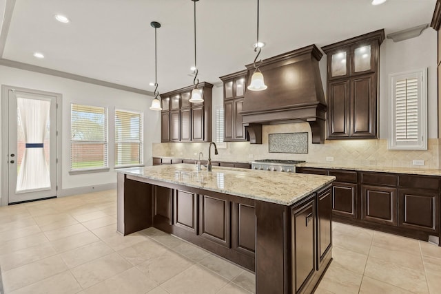 67 Quiet Vista Dr, Sugar Land, TX 77498 - kitchen with custom range hood, a sink, backsplash, an island with sink, and ornamental molding
