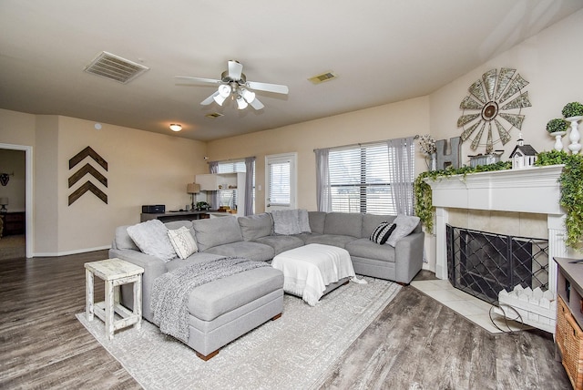 12513 Canyon Hill Dr, Willis, TX 77318 - living area with wood finished floors, a ceiling fan, baseboards, and a tile fireplace