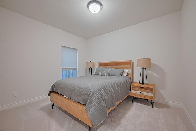bedroom featuring baseboards and carpet