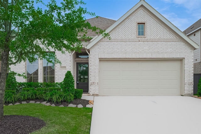 view of front of house with concrete driveway, a garage, brick siding, roof with shingles, and a front lawn