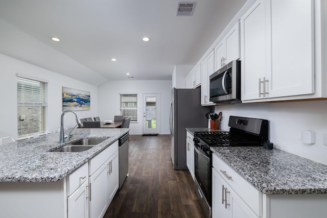 9905 Glenbrook Ln, Magnolia, TX 77354 - kitchen featuring appliances with stainless steel finishes, a sink, dark wood-style floors, white cabinets, and recessed lighting