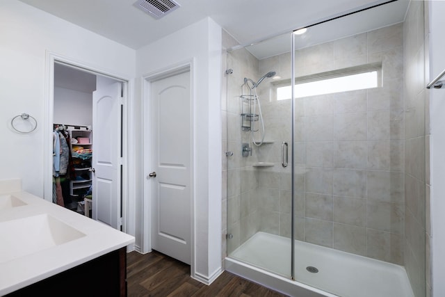 9905 Glenbrook Ln, Magnolia, TX 77354 - bathroom with a shower stall, wood finished floors, vanity, and a walk in closet