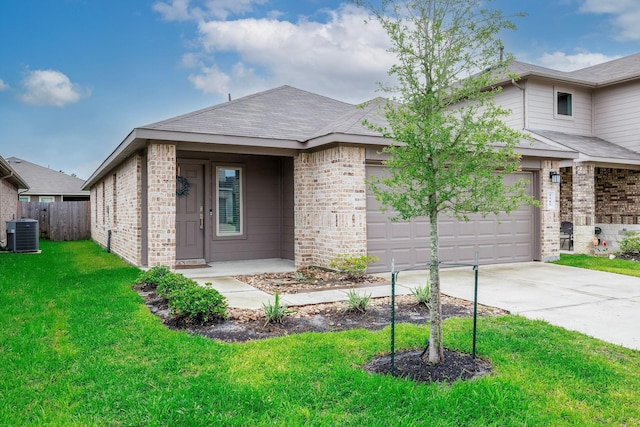 9905 Glenbrook Ln, Magnolia, TX 77354 - view of front of house featuring brick siding, central AC, concrete driveway, a garage, and roof with shingles