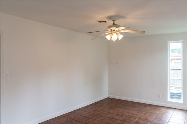 5311 Perry Ave, Galveston, TX 77551 - tiled spare room featuring ceiling fan and baseboards
