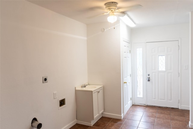 5311 Perry Ave, Galveston, TX 77551 - tiled entrance foyer with ceiling fan, a sink, and baseboards