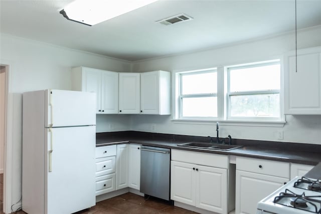 5311 Perry Ave, Galveston, TX 77551 - kitchen featuring white appliances, a sink, dark countertops, and white cabinets