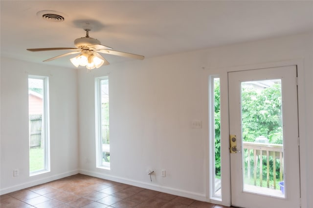 5311 Perry Ave, Galveston, TX 77551 - empty room featuring tile patterned flooring, baseboards, and ceiling fan
