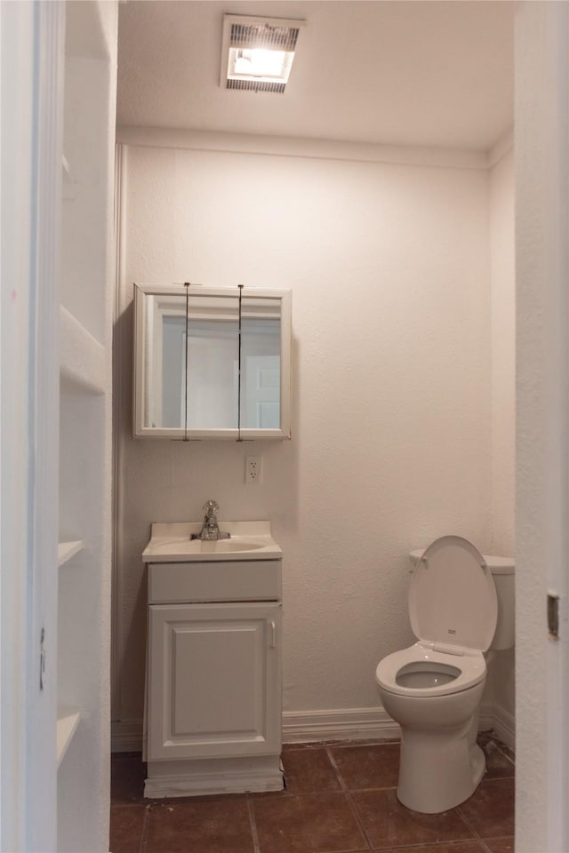 5311 Perry Ave, Galveston, TX 77551 - half bath featuring toilet, vanity, baseboards, and tile patterned flooring