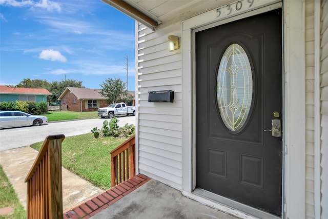 5311 Perry Ave, Galveston, TX 77551 - view of exterior entry with a porch and a yard