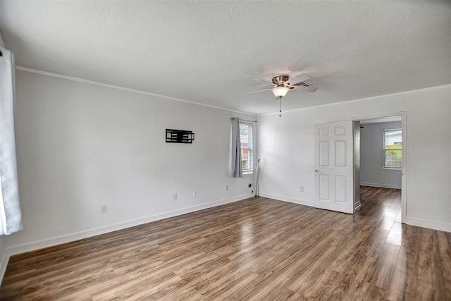 5311 Perry Ave, Galveston, TX 77551 - spare room featuring healthy amount of natural light, crown molding, wood finished floors, a ceiling fan, and baseboards
