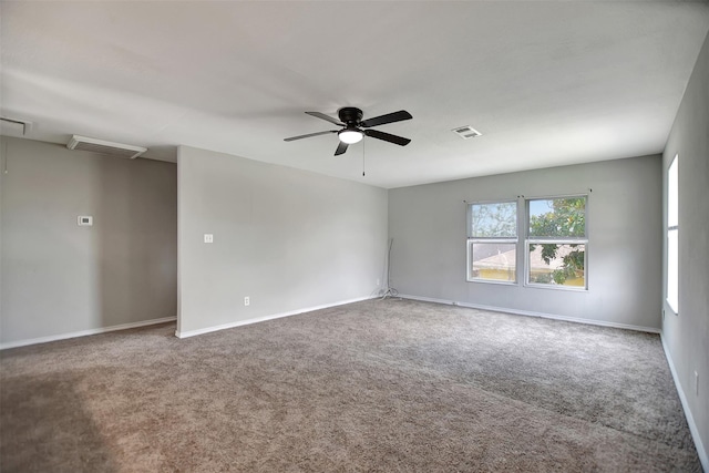 5311 Perry Ave, Galveston, TX 77551 - carpeted empty room with a ceiling fan, baseboards, and attic access