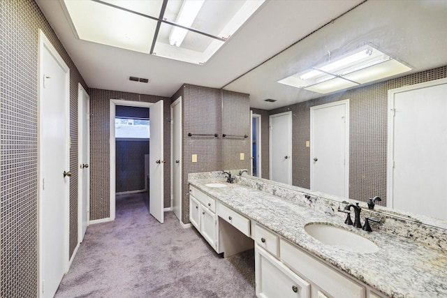 7447 Cambridge St Unit 75, Houston, TX 77054 - bathroom featuring double vanity and carpet floors