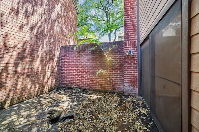 7447 Cambridge St Unit 75, Houston, TX 77054 - view of home's exterior featuring a patio, fence, and brick siding