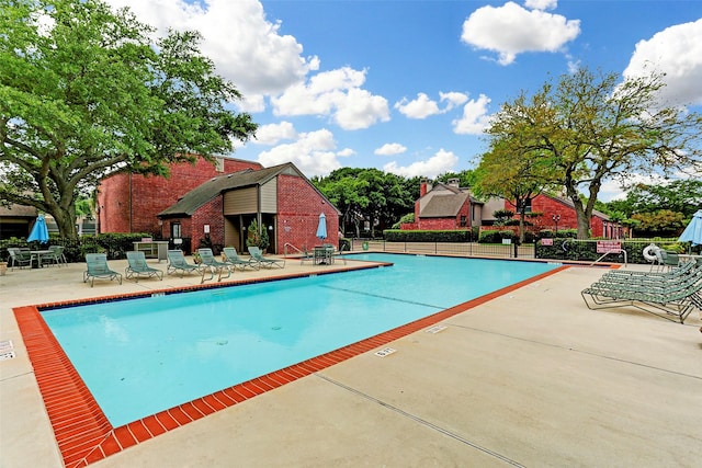 7447 Cambridge St Unit 75, Houston, TX 77054 - community pool with a patio area and fence