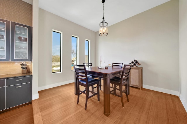 dining area with baseboards and light wood-type flooring