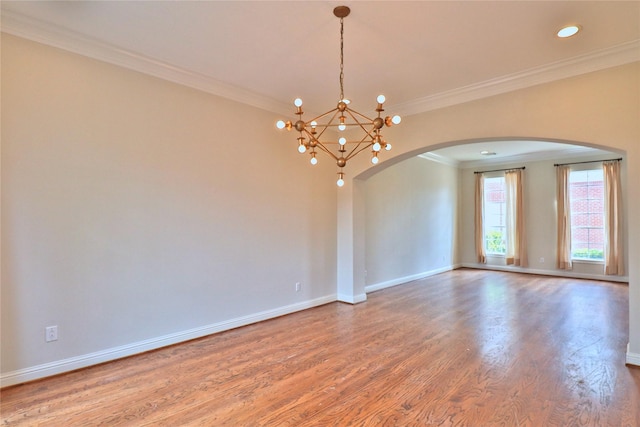 3628 Timberside Circle Dr, Houston, TX 77025 - unfurnished room with arched walkways, crown molding, a chandelier, wood finished floors, and baseboards